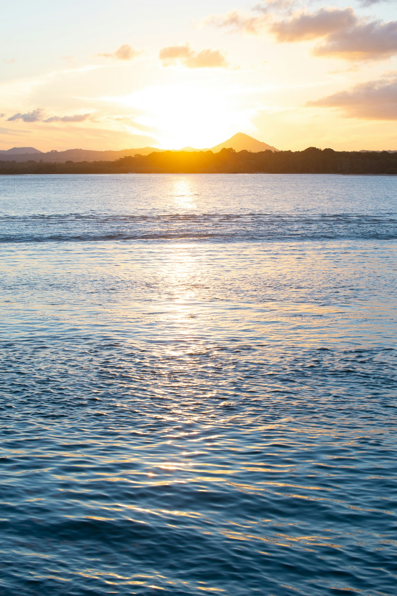 Scenic View of Sunset in a Seascape begin a Mountain.Background.Vertical Image,Noosa Heads,Australia